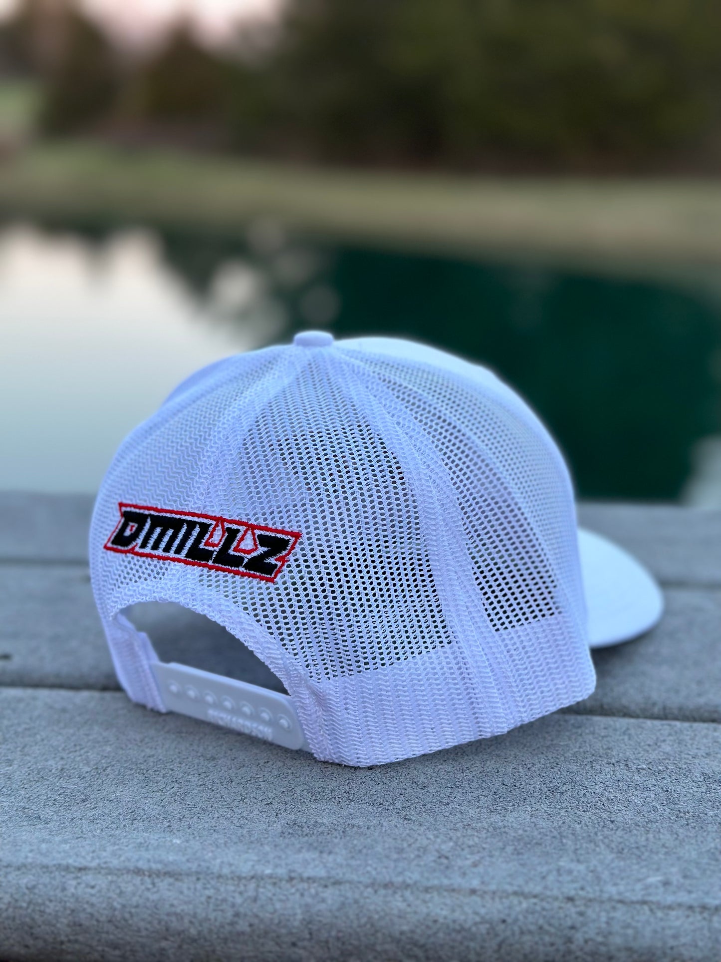 back of white hat with DMILLZ embroidered on rear